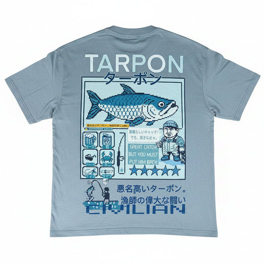 Light blue t-shirt with tarpon fish graphic and text on a textured surface